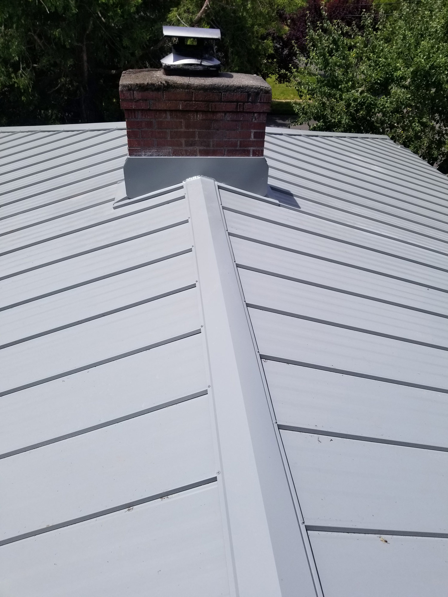 Gray metal roof with chimney